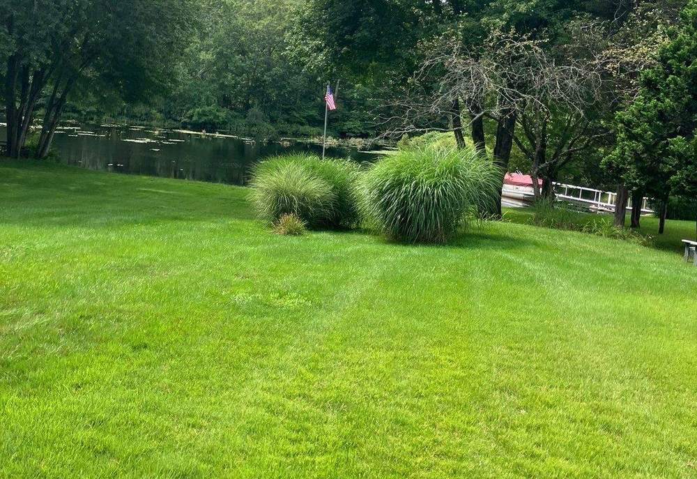 A finished lawn cut clean down to the water at an East Lyme, Connecticut, property