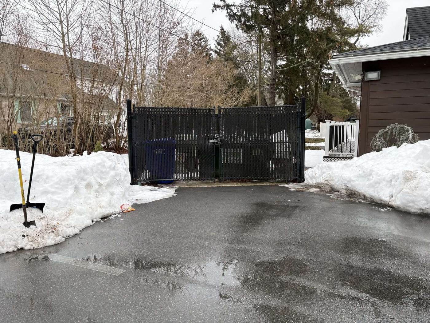 A commercial approach and dumpster pad cleared to blacktop after a storm in southeastern Connecticut by Outdoor Property Services