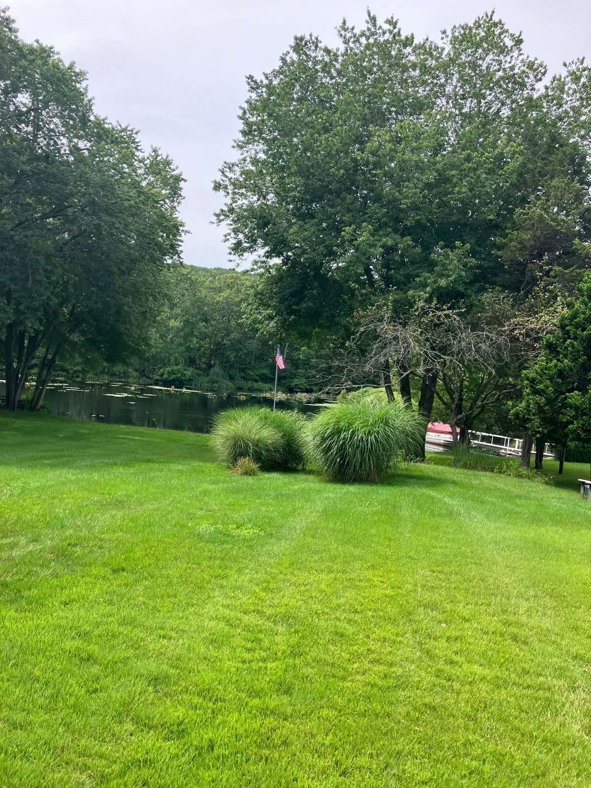 A lawn in East Lyme, Connecticut, mown by Outdoor Property Services right down to the water's edge
