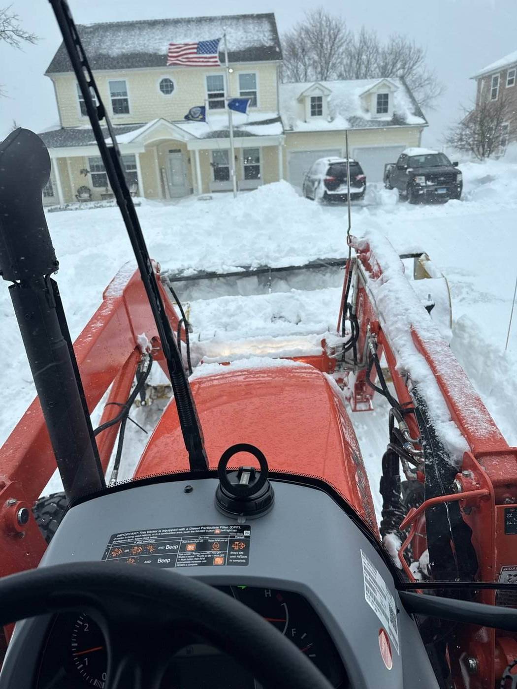 The view from the tractor cab clearing a residential driveway during a storm in southeastern Connecticut
